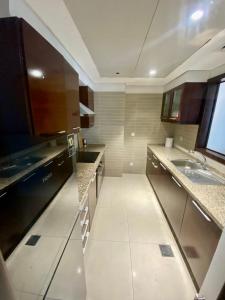 a large kitchen with a sink and a counter at One Constitution Avenue - Apartments by Superhost in Islamabad