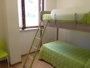 A bed or beds in a room at Tempo Di Sole con Serv Spiaggia