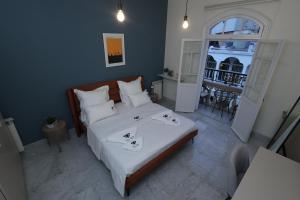 a bedroom with a large bed with white sheets at THE GEM BOUTIQUE HOTEL in Beirut