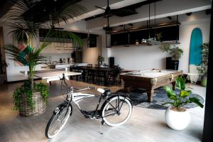 a bike parked in a room with a pool table at H HOTEL in Fukuoka
