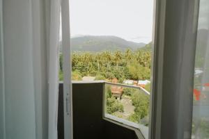 an open window with a view of a garden at Langkawi Homestay at Simfoni Beliza Apartment by Chien in Kuah