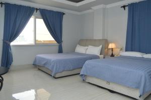 Postel nebo postele na pokoji v ubytování 한라호텔 Halla Hotel