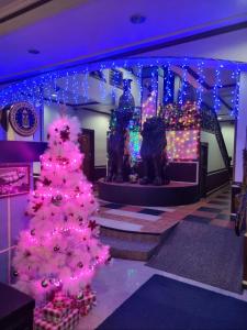 a christmas display with a pink christmas tree and lights at Tiger Hotel in Angeles