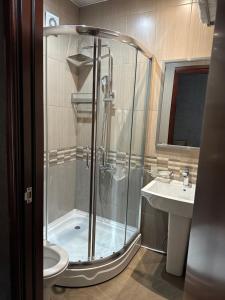 a bathroom with a shower and a sink at jaba palace hotel in Tbilisi City