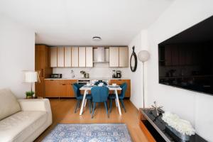 a kitchen and living room with a table and chairs at Lovely 2 Bedroom Apartment in New York