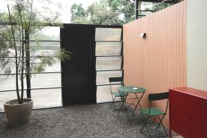 a room with chairs and a table and a tree at 4 bedrooms, Private & Cozy house @ Walking Street in Chiang Rai