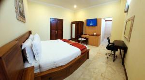 una camera con letto e scrivania di Bali Emerald Apartments a Sanur