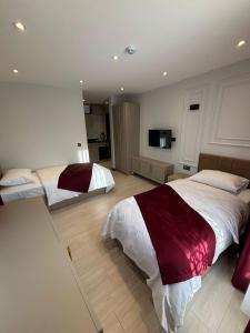 a bedroom with two beds and a flat screen tv at Eyüp Sultan Hotel in Istanbul