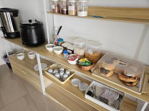 a shelf with food and other food items on it at Sailor Hotel Pattaya in Pattaya South