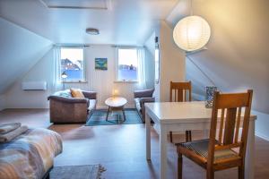 a living room with a table and a couch at Cosy One Villa in Struer
