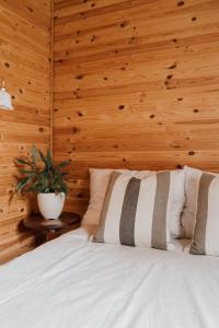 a bedroom with a white bed with a wooden wall at Tranquility with Luxury in Maardu