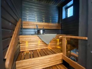 a wooden sauna with a table in it at Upea saunallinen kaksio Sibeliustalon vieressä in Lahti
