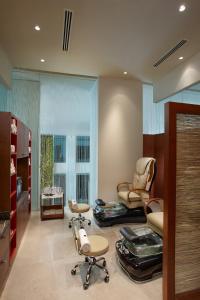 a room with two chairs and a room with a salon at ITC Gardenia, a Luxury Collection Hotel, Bengaluru in Bangalore