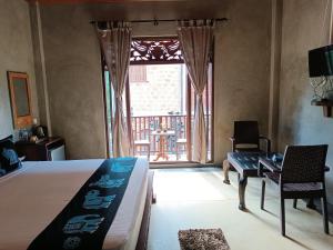 Negombo Boutique Villa في نيجومبو: غرفة نوم مع سرير ونافذة مع فناء