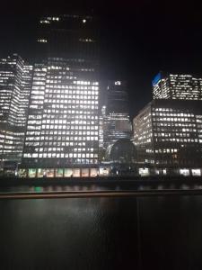 a view of a city at night with lights at Ravishing Riverside 2-Bed Rental in Canary Wharf in London