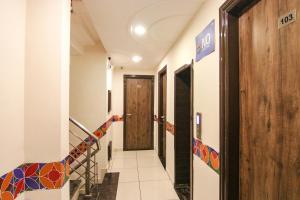 a hallway with a door and stairs in a building at FabHotel Rosewood Inn in Amritsar