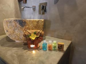 a bathroom with a sink and some bottles on a counter at Negombo Boutique Villa in Negombo