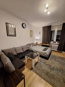 a living room with a couch and a bed at Apartment Centrum in Warsaw