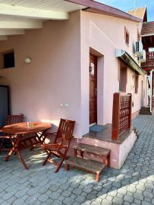 a table and chairs sitting outside of a house at Andrea Apartman in Bük