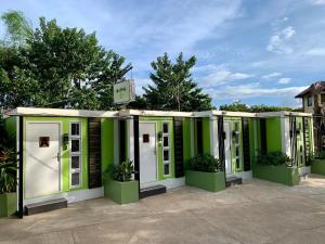 a row of green and white portable toilets at J & J Homestay in Coron