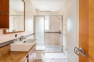 a bathroom with a shower and a sink and a toilet at MUI Pamplona in Pamplona