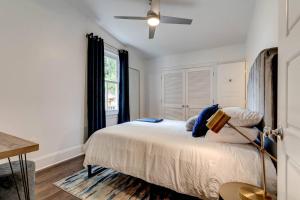 a bedroom with a bed and a ceiling fan at Jazzed On Jackson in New Orleans