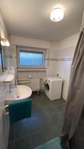 a bathroom with a sink and a toilet at Beautiful Apartment in Ibbenbüren in Ibbenbüren