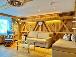 a living room with a couch and a table at Andi's Skihotel in Obertauern