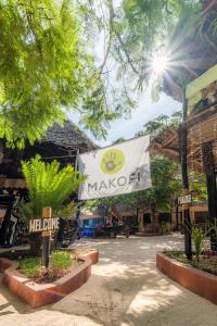 a sign for a market with a marico banner at Makofi Guest House in Nungwi