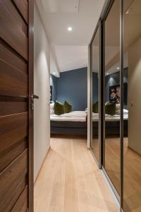 a hallway with a bedroom with a bed and mirrors at Enter Tromsø Luxury Villa in Tromsø