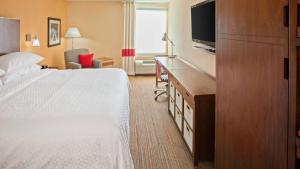 a hotel room with a bed and a flat screen tv at Fairfield Inn & Suites by Marriott Chattanooga in Chattanooga