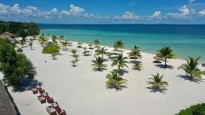 an aerial view of a beach with palm trees and the ocean at The Secret Garden Koh Rong in Koh Rong Island