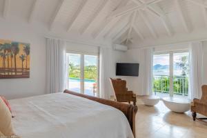 a bedroom with a bed and a view of the ocean at O SUN in Les Terres Basses