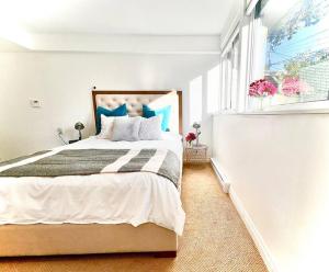 a bedroom with a large bed and a window at 'Canyon Heights' Retreat (Grouse Mountain) in North Vancouver