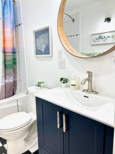 a bathroom with a sink and a toilet and a mirror at 'Canyon Heights' Retreat (Grouse Mountain) in North Vancouver +16 photos