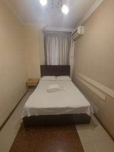 Voodi või voodid majutusasutuse Home Hotel toas