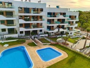 an aerial view of a apartment building with a swimming pool at Luxe Appartement Orihuela Costa - Villamartin -Aire Residencial - green and pool view in Orihuela Costa