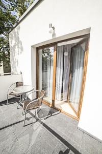 a patio with a table and chairs and a window at Villa Port in Iława