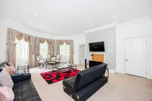 a living room with a couch and a table at Larger Groups Excel Canary Wharf Apartments with Parking in London