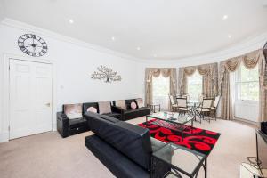 a living room with a couch and a table at Larger Groups Excel Canary Wharf Apartments with Parking in London