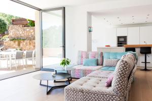 a living room with a couch and a table at Casa KARIAN in Tossa de Mar