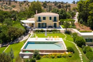 an aerial view of a house with a swimming pool at Villa Aria - Luxury Beachfront Villa with Pool and Tennis Court in Koilás
