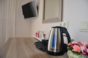 a tea kettle on a counter in a kitchen at Rose Garden Boutique Hotel in Akbük