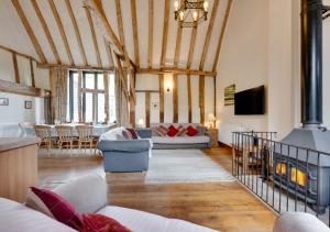 a living room with couches and a fireplace at Tithe Barn at Wattisham Hall in Wattisham