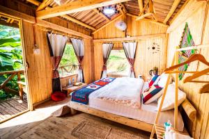 a bedroom with a bed in a room with wooden walls at Then Pa village in Loung Co