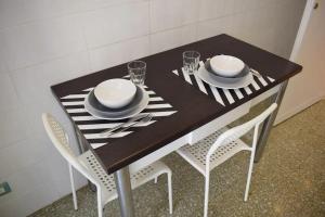 a dining table with two chairs and a black and white table at Locazione turistica Roman style near San Pietro in Rome