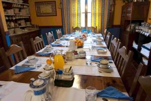 a long table with plates and pitchers of orange juice at Fuente De Las Anjanas in Estrada