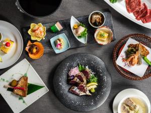 un grupo de platos de comida en una mesa en KAMENOI HOTEL Kochi, en Ino
