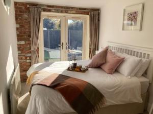 a bedroom with a bed with a table on it at The Stables in Metheringham