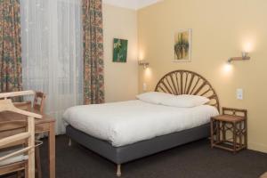 a small bedroom with a bed and a window at Cit'Hotel Aéro-Hotel in Le Blanc-Mesnil